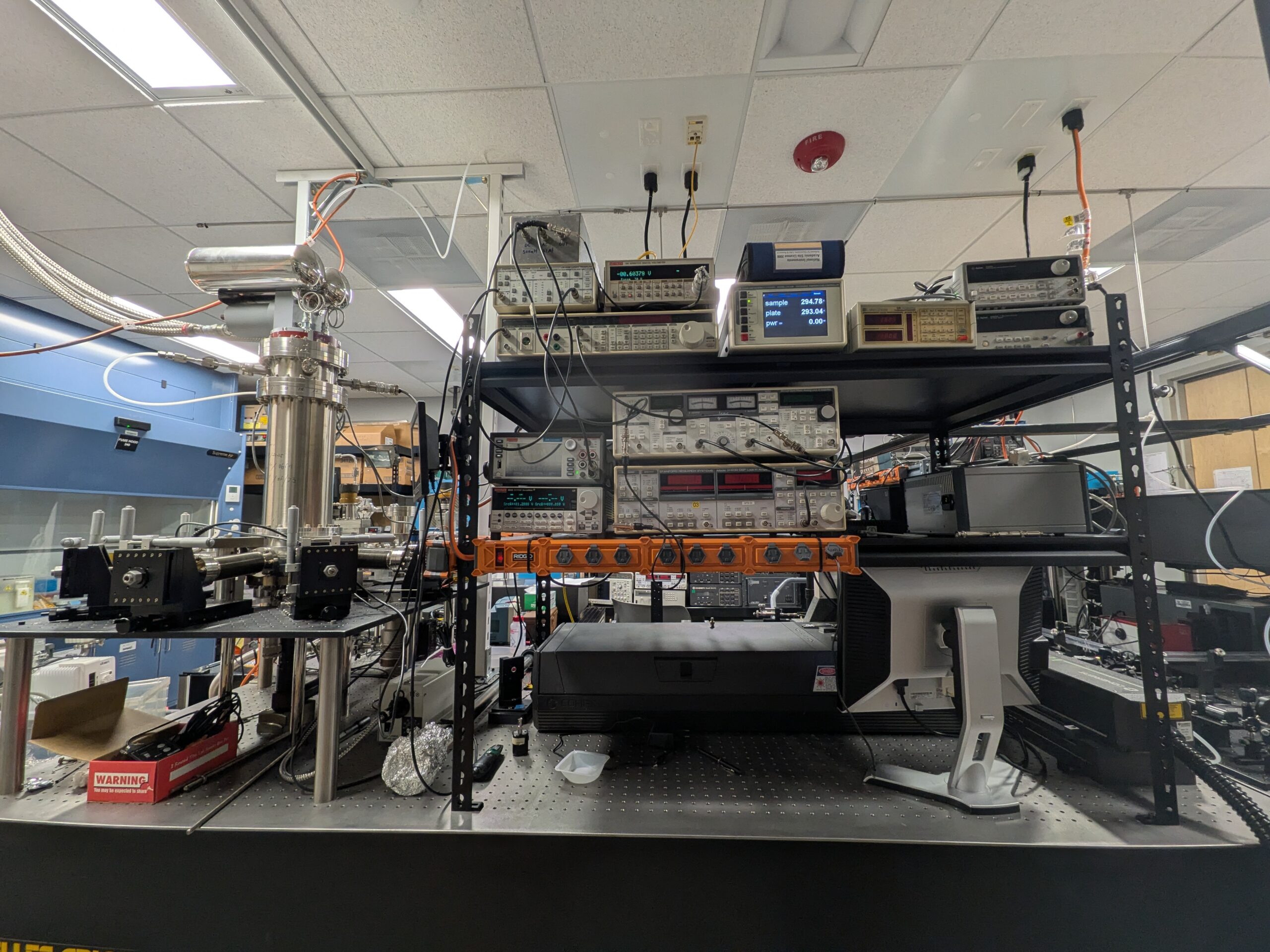 Optical table with cryogenic or vacuum chamber, temperature readouts, and instrument rack