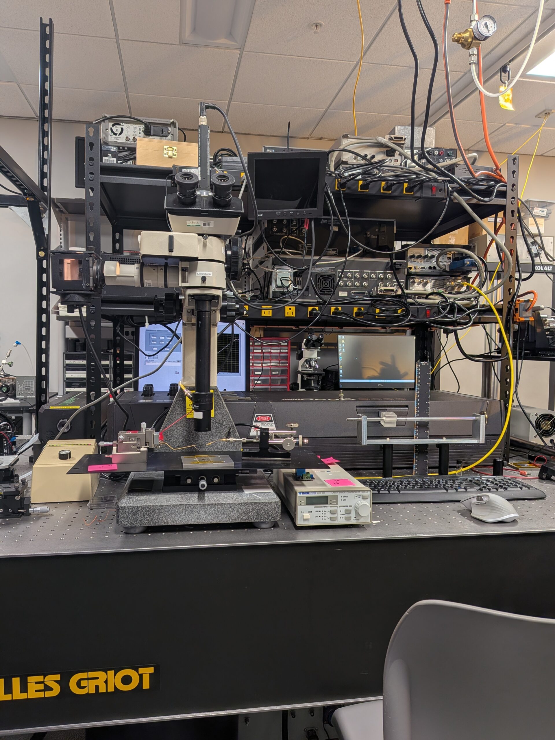 Melles Griot optical table with microscope, Thorlabs controller, and laser hardware