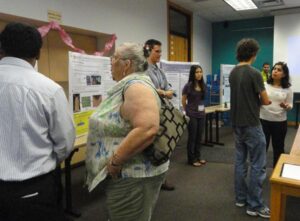 Presenters in front of their research posters