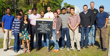 Dr. Seal and research students in front of AMPAC sign