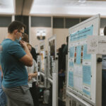 Student looking at research poster