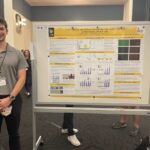 Student with his research poster