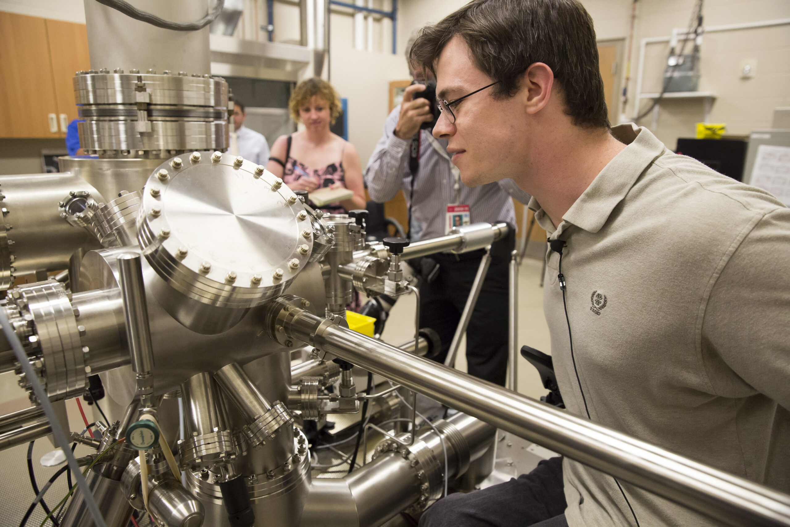 Student looking at machine in lab